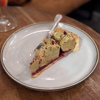 Raspberry tart with pistachio cream at Szklarnia in Krakow