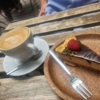 Flat white and raspberry cheesecake at Szklarnia in Krakow