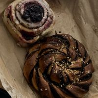 Cinnamon roll with blueberry jam and chocolate pastry   at Szklarnia in Krakow