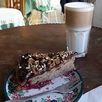 Vegan cake with poppy seed, raspberry sauce and peanut butter crust at Cafe Katulki in Berlin