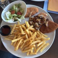 Vegan Schnitzel with fries, a side of baked mushrooms and ketchup  at Cafe Del Sol in Hamm