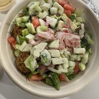 Bowl with jasmine rice, falafel, lettuce, tomato, cucumber, and tahini  at Hummus in Holbrook