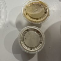 Top is regular hummus, bottom is extra side of tahini  at Hummus in Holbrook