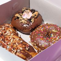 S’mores donut, chocolate sprinkles donut and pecan brownie cream foldover.   at Grumpy & Runt in Western Cape
