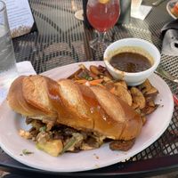 Vegan Banh Mi with fries and pomegranate ginger spritz  at Ramsi's Cafe on the World in Louisville
