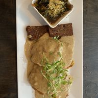Biscuits and gravy with tempeh bacon and greens  at Box Bar in West Seattle