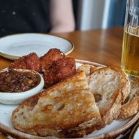 Starter of Vegan Deep Fried Camembert Bites and Sourdough with Sweet Jam/Chutney. at Peachy Goat in South East London