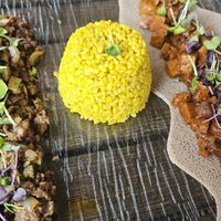 Soy kifto (left), turmeric rice (middle), and seitan tibs (right) at Ras Plant Based in Brooklyn