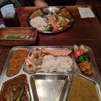 Top: dal bhat set (1 curry - potato) bottom: maitiighar set (2 curries - vegetable / lentil)
Both with veggie Momo, lentil soup and curried potato at Maitiighar Nepali in Fukuoka