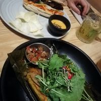 Envuelto criollo and banh mi. The cocktail is with coca aguardiente and maracuya. at INA Restaurante in Medellin