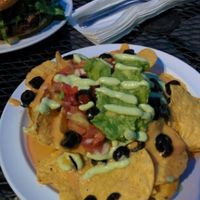 small size nachos: refried beans, some tomatoes, guacamole, black olives, 'cheese' sauce at Garden to Grill in Sacramento