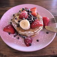 Stack of 3 pancakes, banana and strawberry  at Vegbox Cafe in Exeter