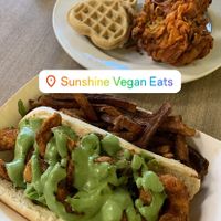 “The Jefferson” shrimp po’boy, chicken and waffles, and “Blu Magic” juice  at Sunshine Vegan Eats in Buffalo