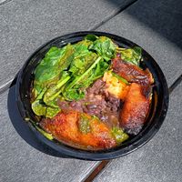 Vegan bowl with yellow rice, black beans, plantains, spinach and chimichurri at Rum Cake Lady in Blue Ridge