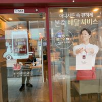 Front of the restaurant and their takeaway-app advertisement at Bonjuk 본죽 - Geumcheon in Seoul