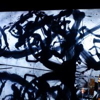 Moving Art (calligraphy) on a huge screen at Vegan Ramen UZU Kyoto in Kyoto