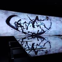 The restaurant is one giant table, with a digital art installation by TeamLab. at Vegan Ramen UZU Kyoto in Kyoto