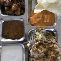 Thali includes aloo Danzig, sushi paneer, dal, rice plus more at Best Indian Restaurant in Almere