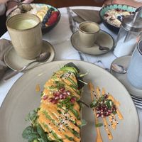 vegan avocado bread w/ pomegranate seeds & spicy mayo 🌶  at Holy Nosh Deli in Kassel