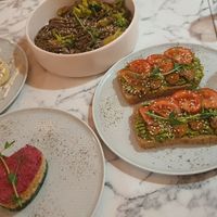 From left to right: tofu cheesecakes, soba noodles, raw salad, avocado toasts at Veg Harmony in Minsk