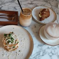 Lasagna, cherry ice latte, banana almond butter croissant, cocoa at Veg Harmony in Minsk