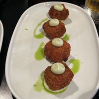 ARANCINI AL POMODORO $15.00
Tomato sugo rice bites served with basil mayo (GF, O) More delicious morsels on the banquet.  at Nonna's Nightmare in West End