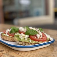 Avo, tomato, basil and vegan feta on a mixed seed bagel  at Bricklane Bagels in South Melbourne