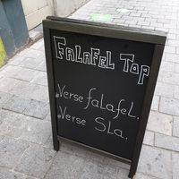 sign on pavement at Falafel Top in Leuven