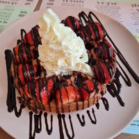 Waffle with strawberries, chocolate sauce, and whipped cream at Heart-Garden Waffles & Coffee in Amsterdam