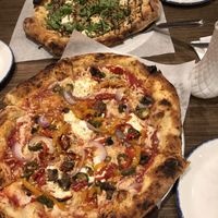 Build your own (near pizza) and Vegan Artichoke Pizza from the menu (far pizza) at The Hall's Pizza Kitchen in Oklahoma City