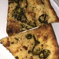 Build your own pizza with garlic sauce, cheeses, and jalapeños at The Hall's Pizza Kitchen in Oklahoma City