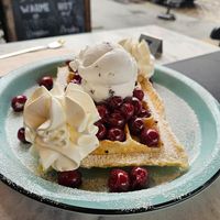 Stracciatella with warm cherries and whipped cream. And no those are matchstick head sizes cherries, there normal sized at IceLab NiceCream Creations in Antwerpen