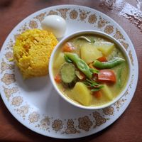 Curry bowl with turmeric rice and egg at Chia Eatery in Dumaguete