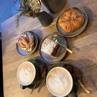 Vōiroos (croisant kind of thing), Cinnamon roll with raspberry creme, Napoleon cake and cafe lattes with caramel suryp, one with oat milk and one with pea milk  at Kringel in Tallinn