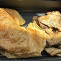 Portobello Croissant Sandwich with fresh, gently seasoned toasted Cauliflower chips.  at Roots PBC in Atlanta