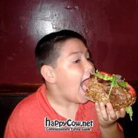 My son trying to navigate the HUGE Philly cheese-fake (vegan version) at Liquid Earth in Baltimore