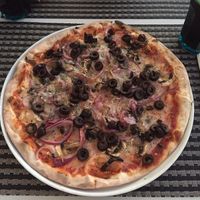 Vegan pizza with mushrooms, onion, olives and vegan cheese at La Pizza in Tavira