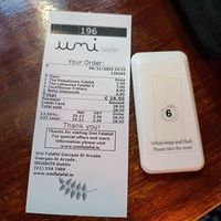 Receipt and a device to tell you when your order is ready at Umi Falafel - George's St Arcade in Dublin