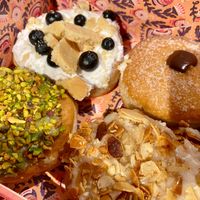 Blueberry cheesecake, chocolate, pistachio, and Bienenstich at Brammibal's Donuts - Friedrichshain in Berlin