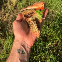 A slice of the verdura pizza (vegan cheese, tomato sauce, eggplant, broccoli, fresh mushrooms, artichokes, onions) at Pizza Huus in Bern