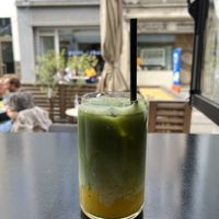 Iced mango matcha latte  at Oats Day Long in Ghent