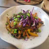 Wok with crispy soya pieces, noodles veggies in a very tasty sauce at Kozy Eats  in Riga