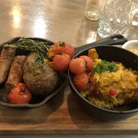 Oven baked potato with Beyond meat sausage and stewed cabbage   at Kozy Eats  in Riga