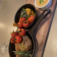 This is a baked potato with sausage - together with something like sauerkraut and a sauce. Really good! Also, the Chianti is very nice 🍷  at Kozy Eats  in Riga