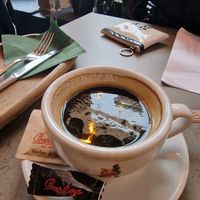 Coffee comes with chocolate covered coffee bean at Kozy Eats  in Riga