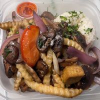 Crispy Tofu & Mushroom Saltado Platter served with Garlic Creole Rice! All the Flavor, Flambé and Umami of Classic Peruvian Lomo Saltado but made thoughtfully Vegan!  at Rocoto Peruvian Kitchen in Portland