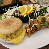 A savory plate, with a muffin, tofu steak and vegan cheese accompanied by kale salad at Maison Sukoon in Paris