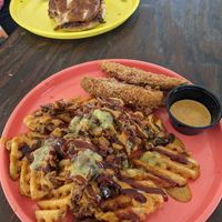 Loaded fries and fried pickles. How High bbq jackfruit sandwich in the background. at Twisted Plants in Cudahy