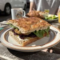 Danish “delle” sandwich with mayo, red cabbage, pikled cucumber, fresh spinach and a vegan fish patty (?)  at Cafe Harepus in Aarhus