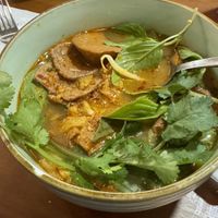 Royal spicy noodle bowl. Trumpet mushroom fritters in background.  at The Kind Bowl - Somerset in Central Singapore